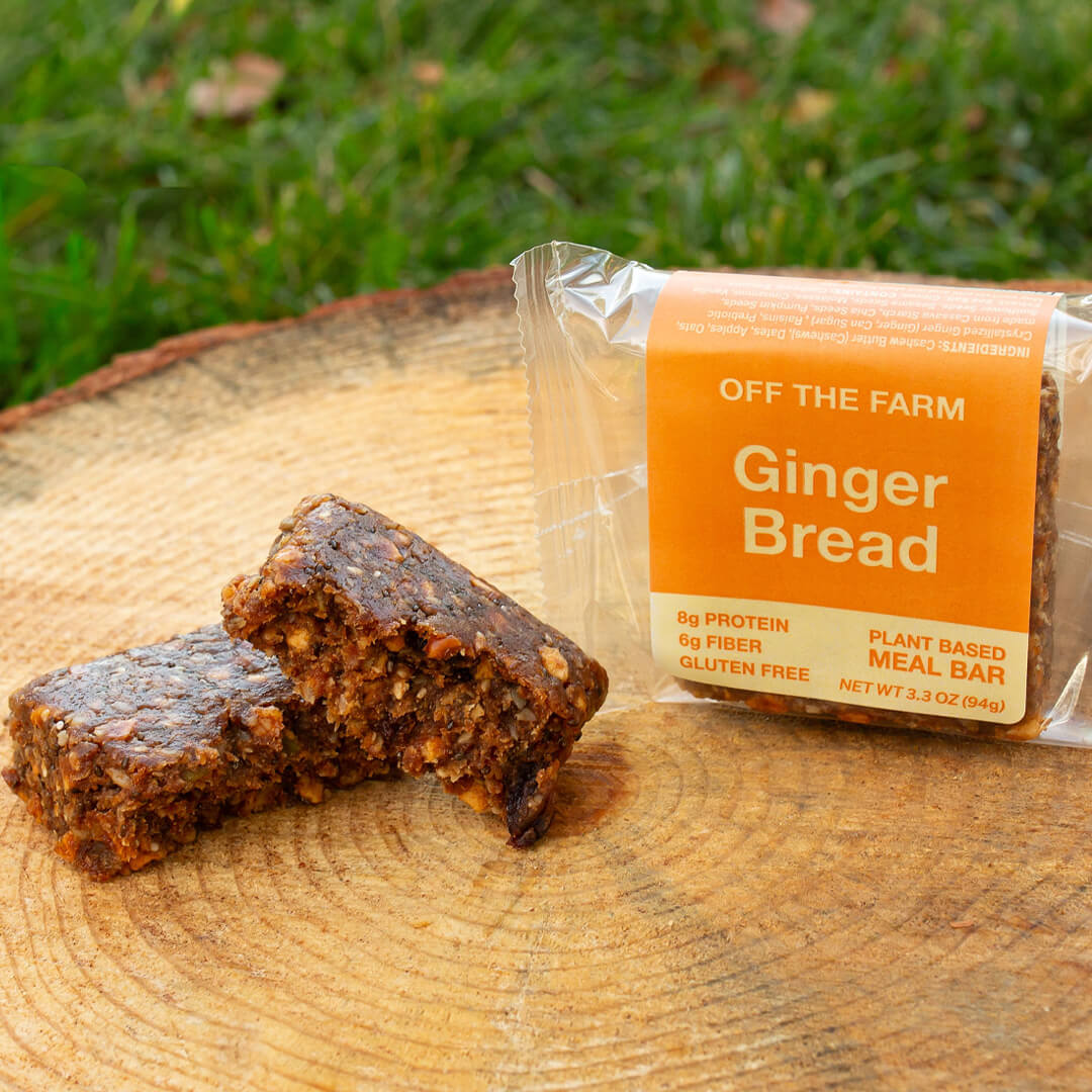 Gingerbread meal bar with packaging on a wooden surface outdoors