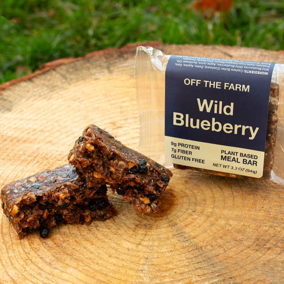 Wild Blueberry meal bar with packaging on a wooden surface
