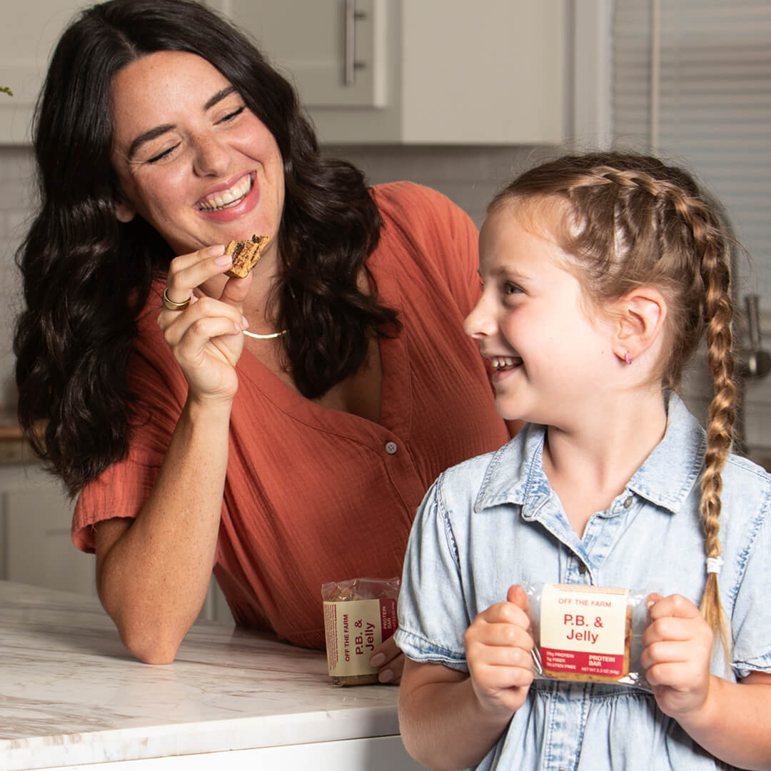 Woman and child in a kitchen with OFF THE FARM PB & Jelly protein bars