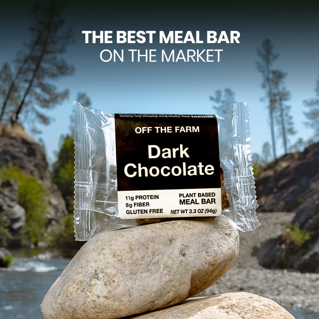 Dark chocolate meal bar packaging on a rock with nature background