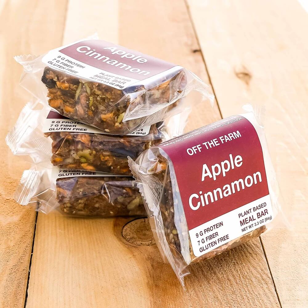 Apple Cinnamon meal bars from 'Off The Farm' on a wooden surface
