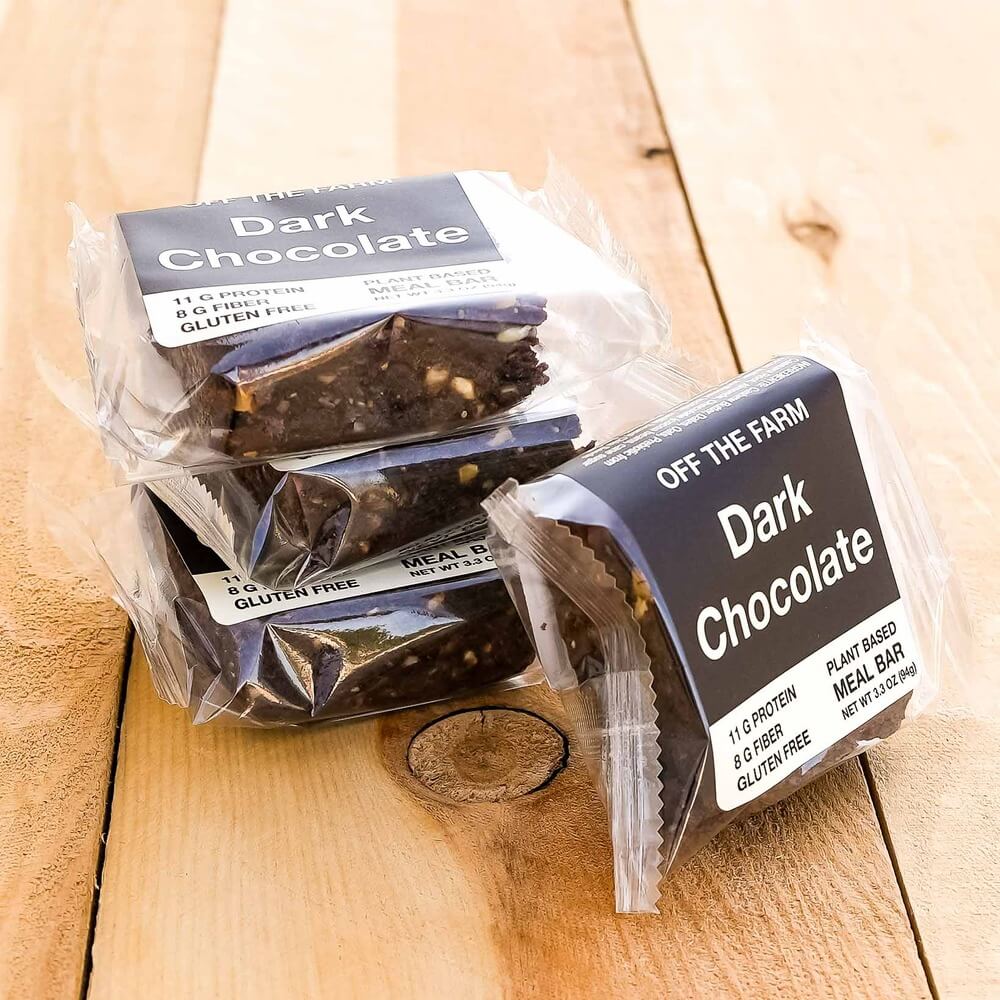 Dark chocolate meal bars from 'Off The Farm' on a wooden surface