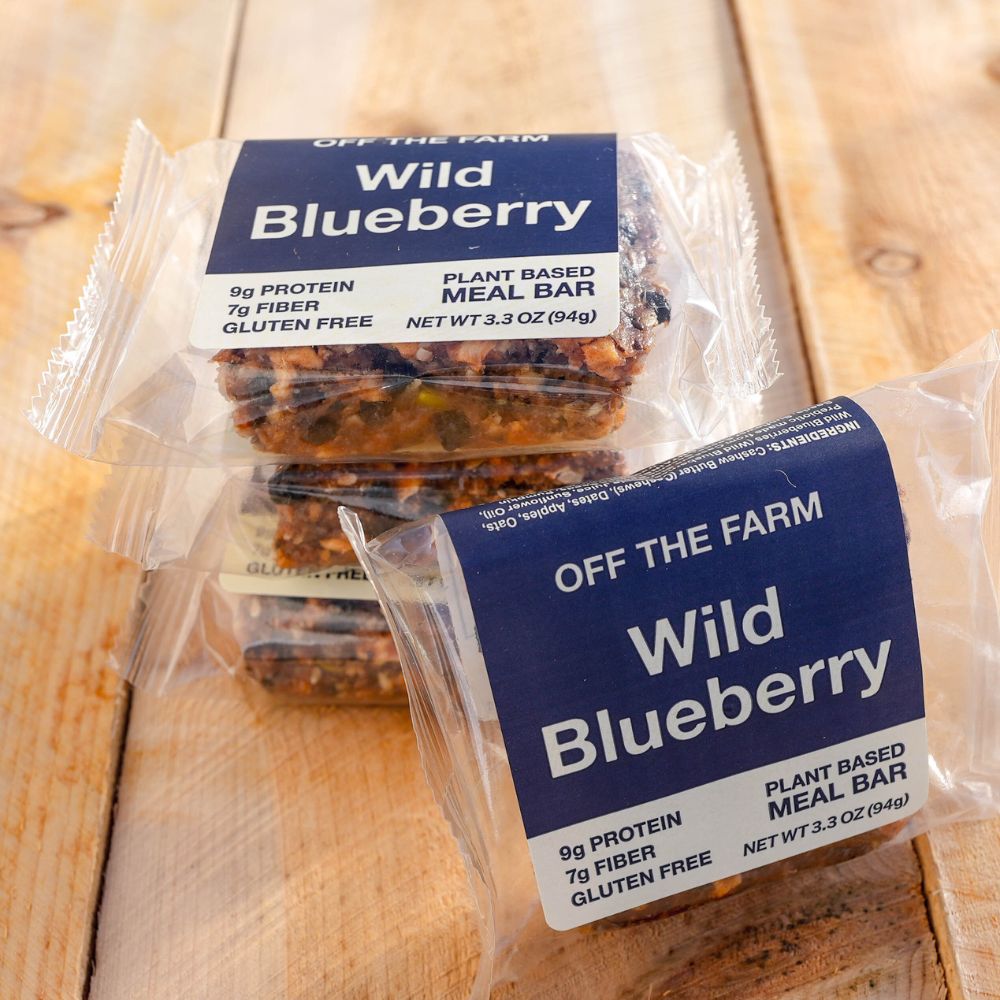 Wild blueberry meal bars sitting on a wood table.