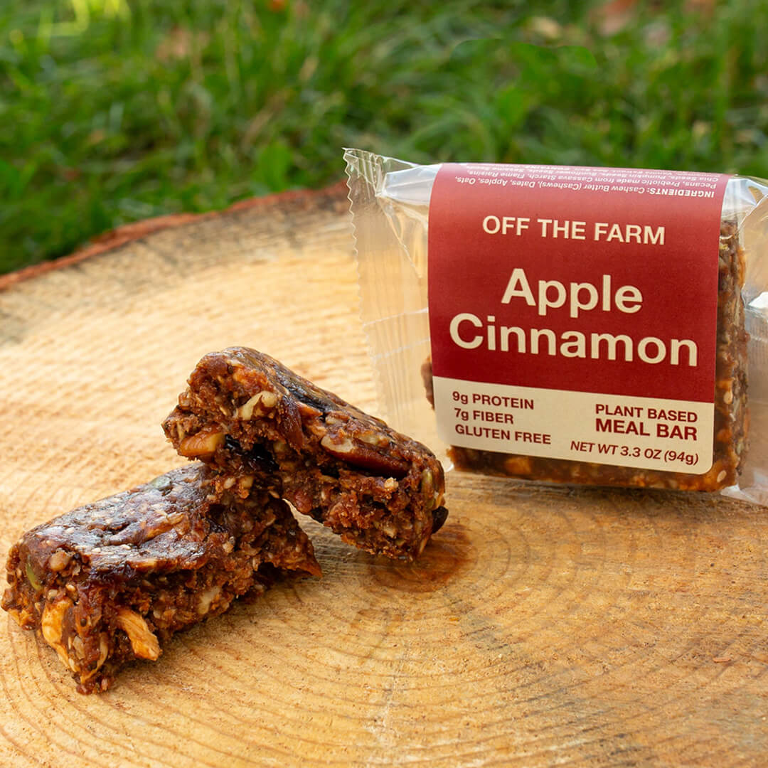 Apple Cinnamon meal bar with packaging on a wooden surface