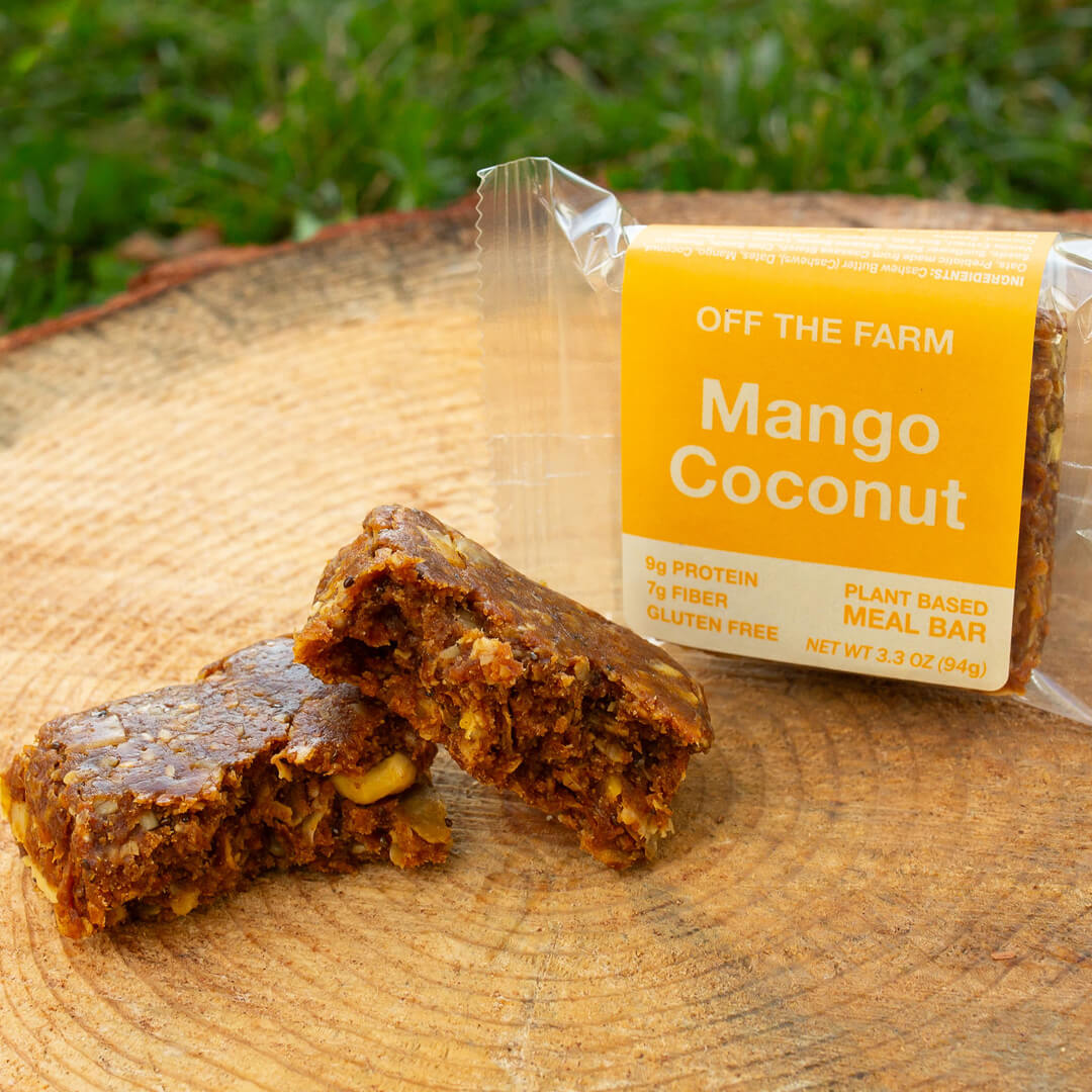 Mango Coconut meal bar with packaging on a wooden surface