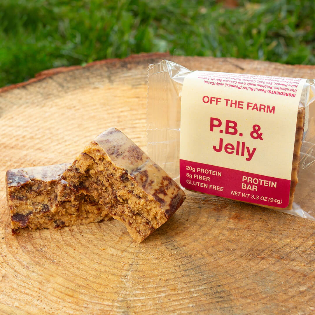 Protein bar with 'Off the Farm P.B. & Jelly' label on a wooden surface