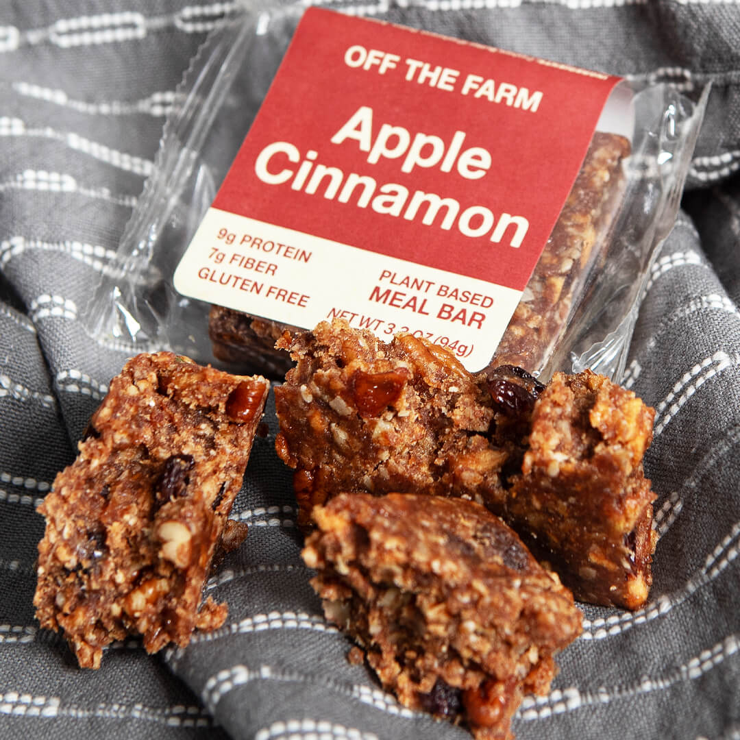 Apple Cinnamon meal bar with packaging on a checkered fabric background