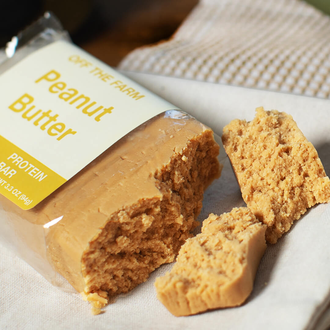 Peanut butter protein bar broken up on a white surface