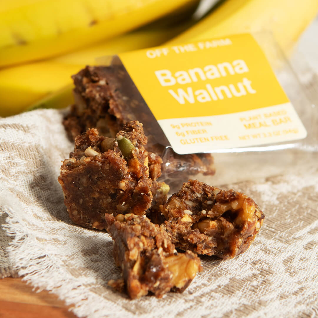 Banana Walnut meal bars with a package on a wooden surface