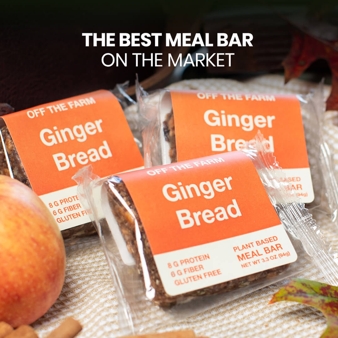 Gingerbread meal bars with orange labels on a woven surface.