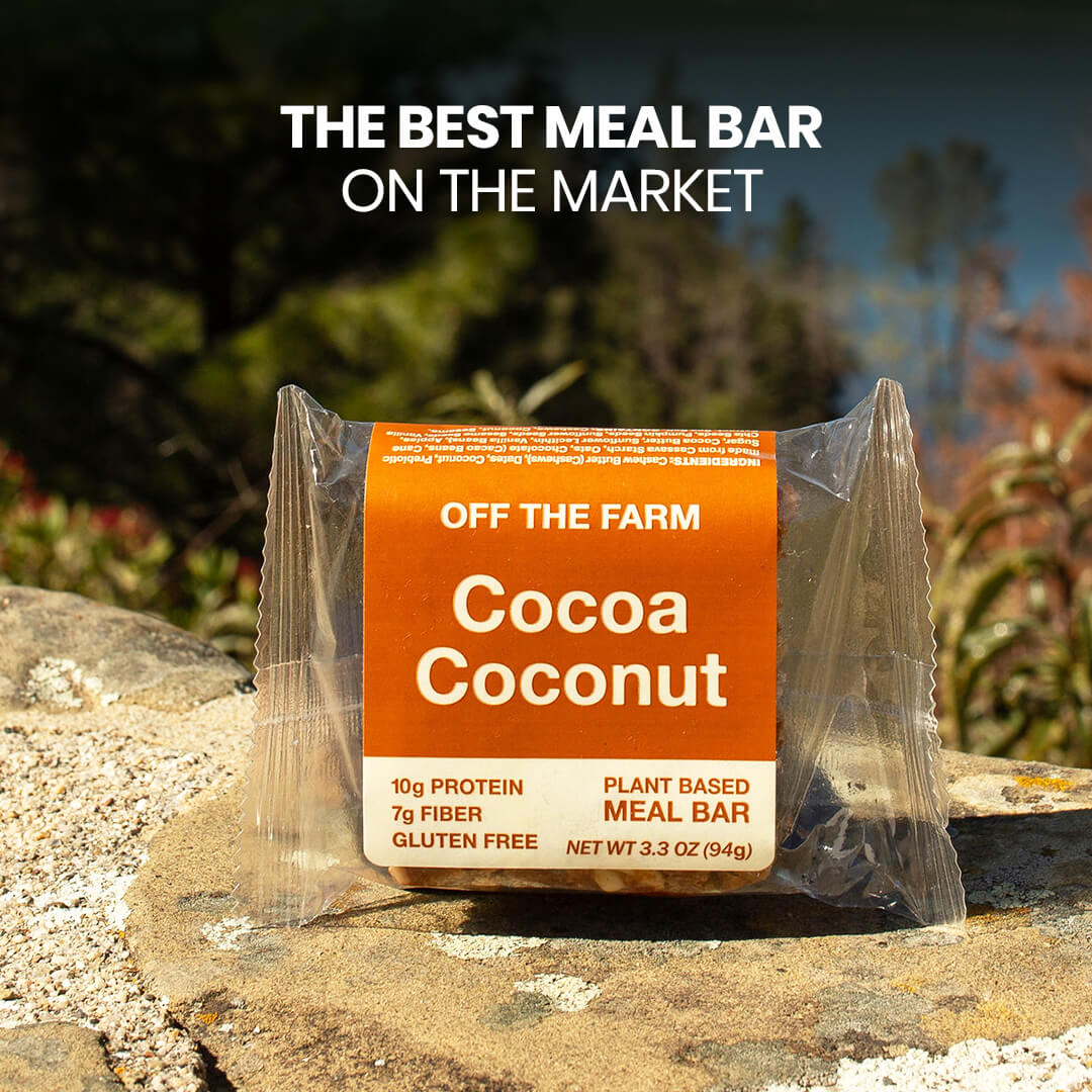 OFF THE FARM Cocoa Coconut meal bar packaging on a rock with outdoor background
