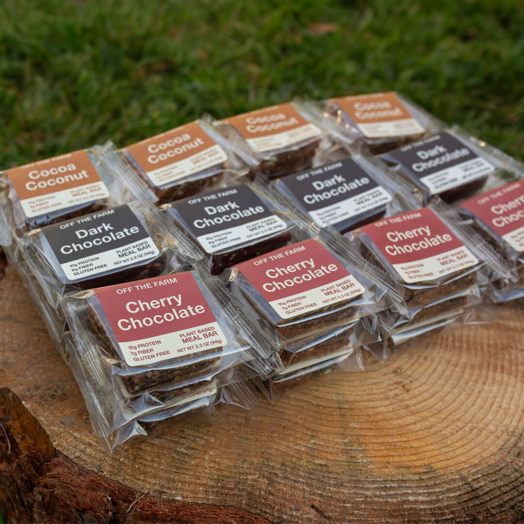 OFF THE FARM assorted chocolate meal bars on a log