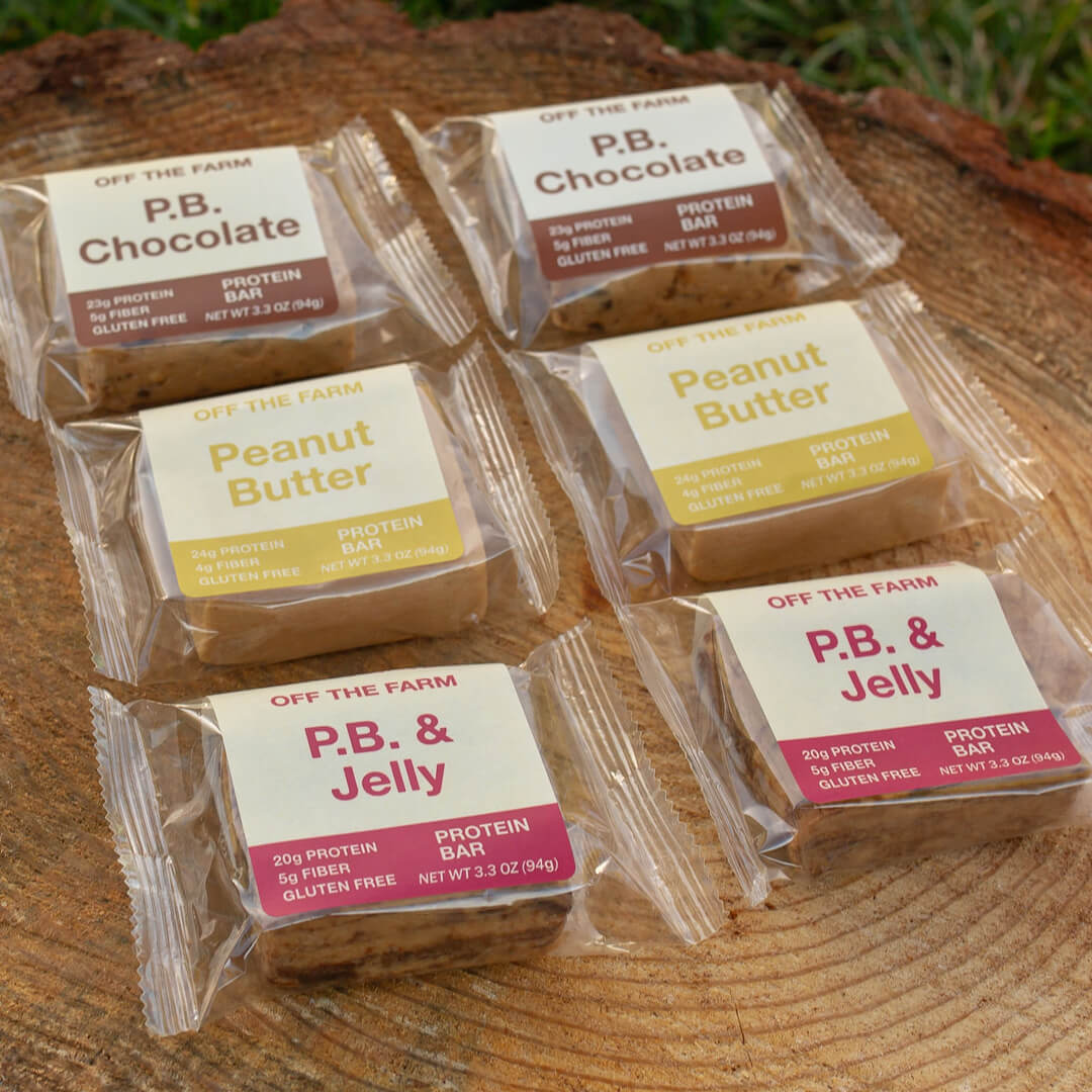 assorted OFF THE FARM protein bars on a log